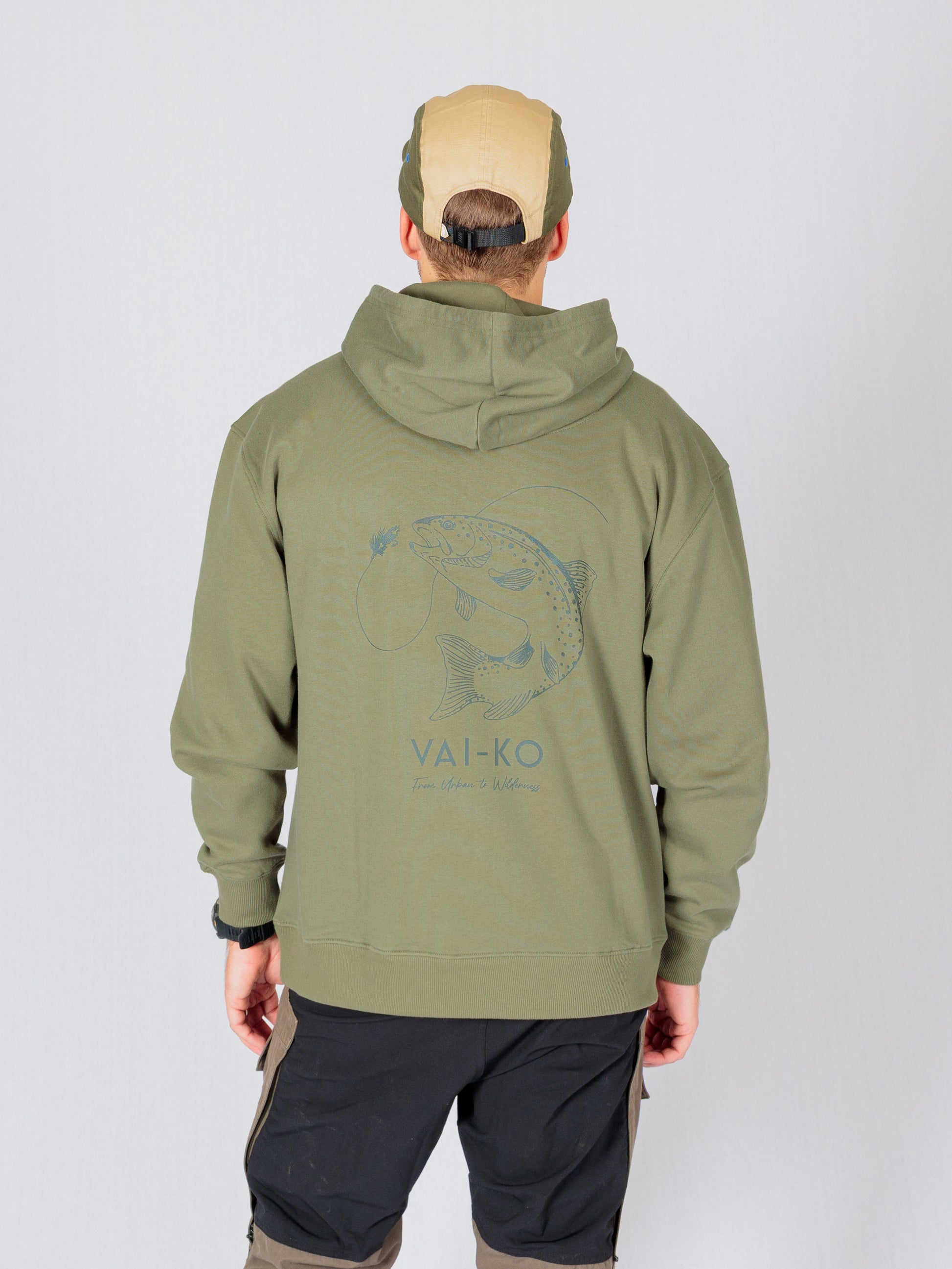 Person wearing an olive green hoodie with a fish graphic and VAI-KO text on the back, facing away.