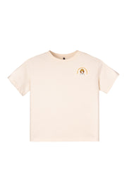 Cream-colored t-shirt with a small graphic of a dog and yellow text on the upper left chest area.