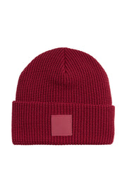 Dark red ribbed knit beanie with a folded cuff and a square patch on the front.