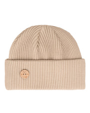 Beige ribbed knit beanie with a folded brim and a round wooden logo pin on the front.